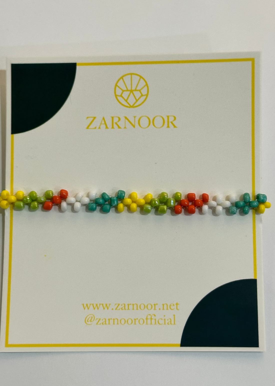 Colorful beaded bracelet on a Zarnoor branded card with a white background